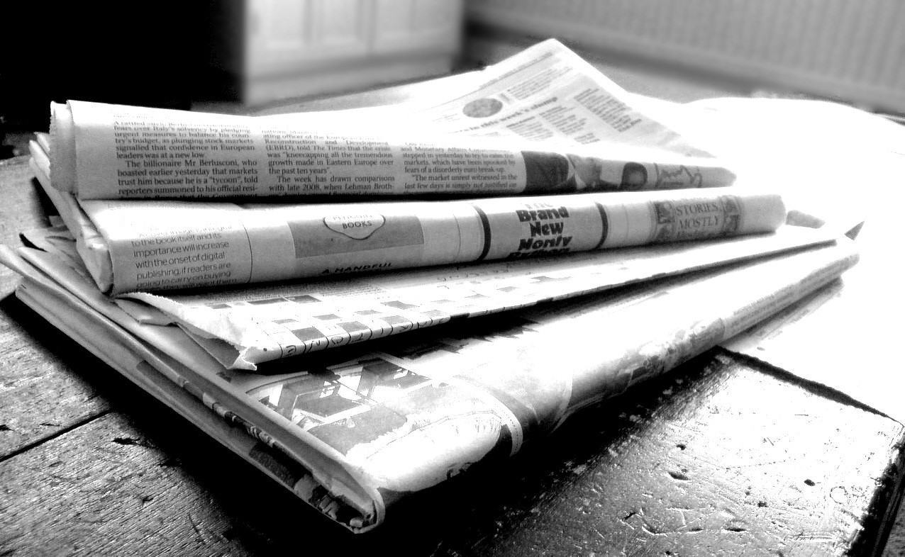 paper news in a table, black and white