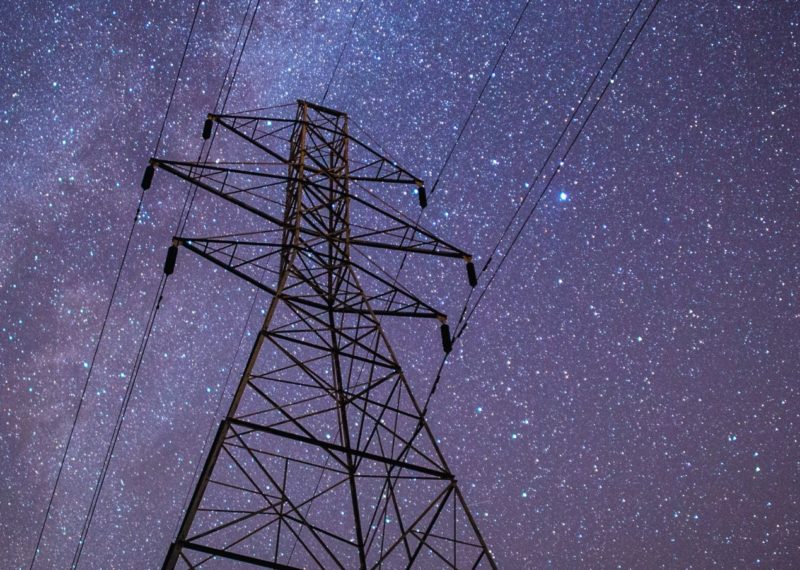 electrical tower at night with stars in the sky