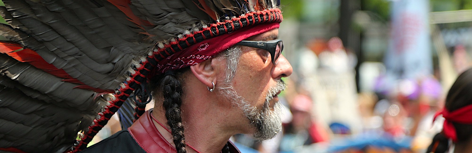 Native amercian protestor with headdress and glasses