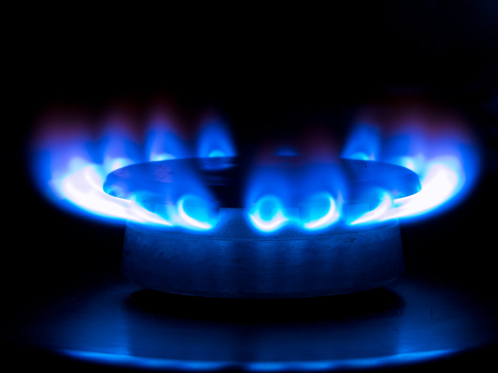 blue flames from a gas stove in the dark