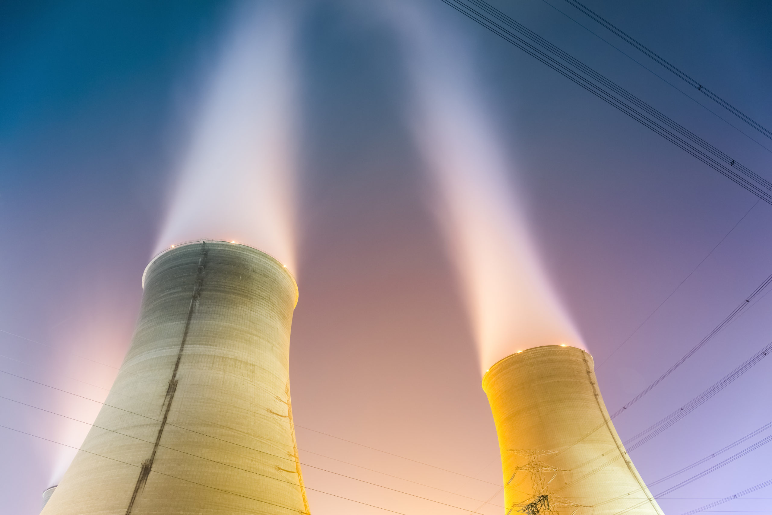 the cooling towers at night of a nuclear power generation plant