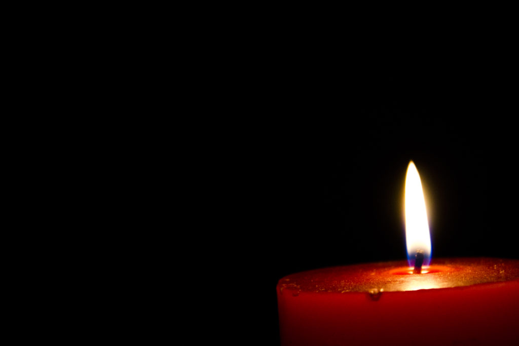 a candle lighting the darkness
