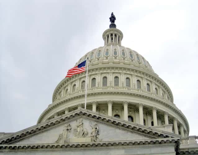 View of the dome of the Capitol building and the US flag in front of it