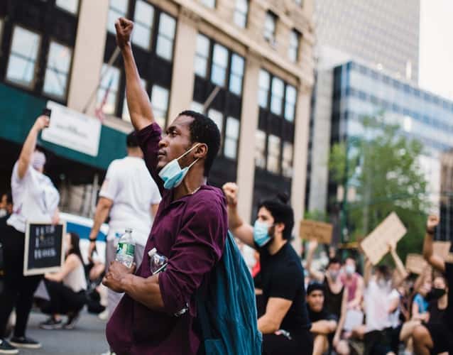 black man with fist up during protest
