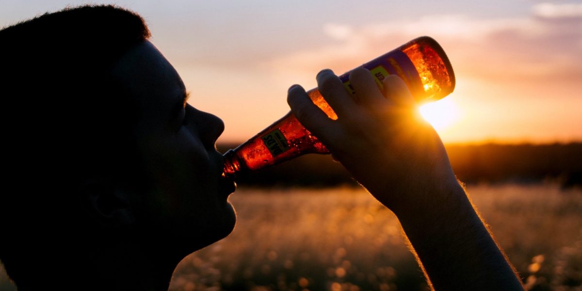 guy drinking beer at the sunset