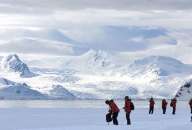 peolple walking in the ice in the Arctic