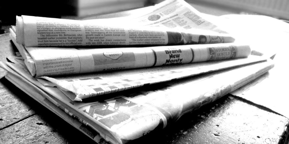 paper news in a table, black and white
