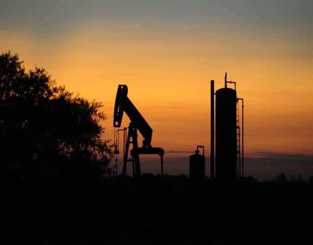 oil derrick pump and tank photo taken during sunset