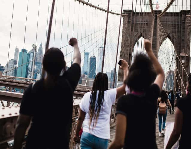 fists up during a protest on a bridge