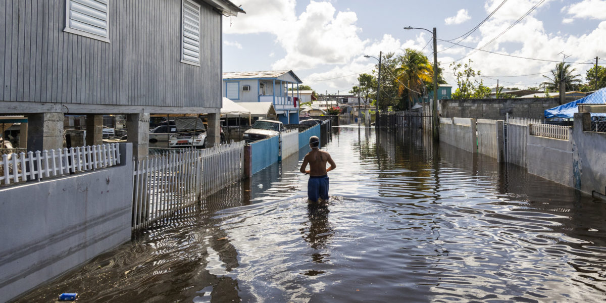 A man walks through a flooded street to get to his home in Juana Matos, Cataño, Puerto Rico. Credit: FEMA/Yuisa Ríos