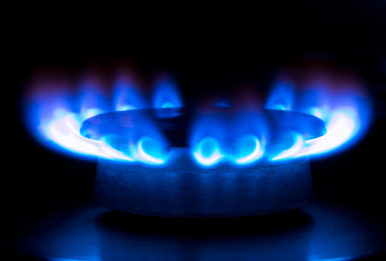 blue flames from a gas stove in the dark
